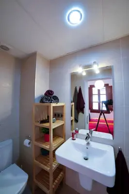 a bathroom with a sink and a toilet and a mirror at barceloneta street apartment 1 in Barcelona