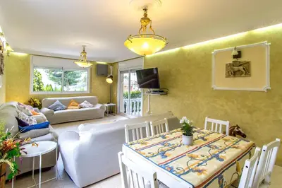 a living room with a table and a couch at Catalunya Casas Costa Dorada Paradise, 2 km from beach! in Cunit