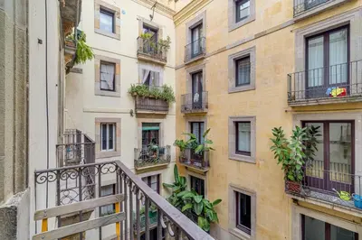 an apartment building with balconies and plants at Guest Ready - Modern apartment by Barcelona Port in Barcelona