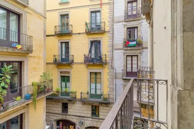 a tall building with balconies and windows and a staircase at Guest Ready - Modern apartment by Barcelona Port in Barcelona