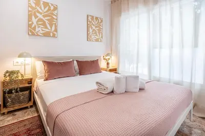 a bedroom with a large bed with towels on it at Charming 3-Bedroom Flat in the Heart of Les Corts in Barcelona
