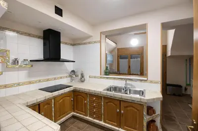 a kitchen with a sink and a mirror at Winahost les Faldas del Montseny in Sant Pere de Vilamajor