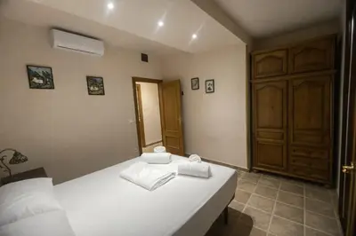 a bedroom with a white bed with towels on it at Winahost les Faldas del Montseny in Sant Pere de Vilamajor