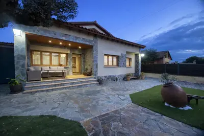 a house with a patio with a couch in it at Winahost les Faldas del Montseny in Sant Pere de Vilamajor
