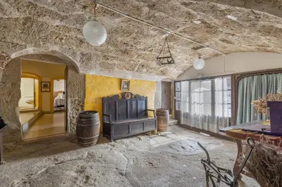 a living room with a couch and a table at Masia Brugarolas in Castelltersol