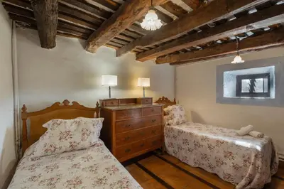 a bedroom with two twin beds and a dresser at Masia Brugarolas in Castelltersol