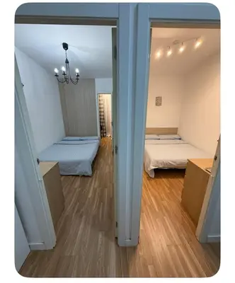 a view of a room with two beds and a mirror at Badalona Old town in Badalona
