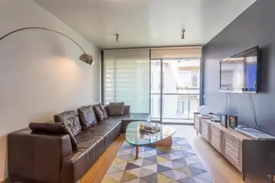 a living room with a couch and a tv at Apartment Barcelona Rentals - 3 bedroom penthouse with large terrace in Barcelona