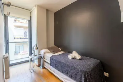 a bedroom with two beds and a window at Apartment Barcelona Rentals - 3 bedroom penthouse with large terrace in Barcelona