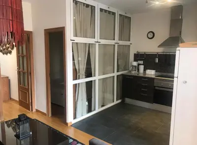 a kitchen with a large glass cabinet in the middle at Apartment Poble Nou in Barcelona