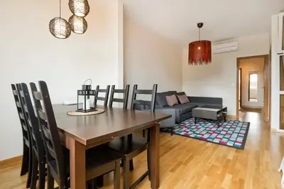 a dining room with a table and a couch at Apartment Poble Nou in Barcelona