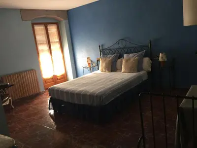 a bedroom with a bed with a blue wall at HOTEL RESTAURANT TURÓ de la TORRE in Manresa