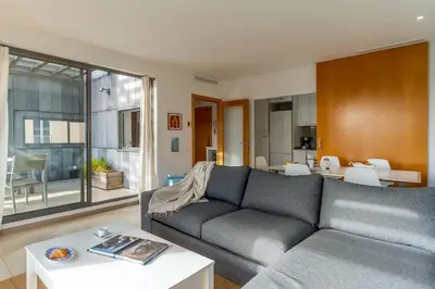 a living room with a couch and a table at Canela Homes BARCELONA POBLENOU in Barcelona