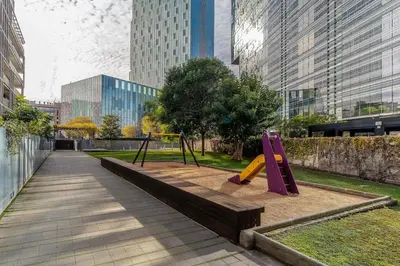 a playground in a city with tall buildings at Canela Homes BARCELONA POBLENOU in Barcelona