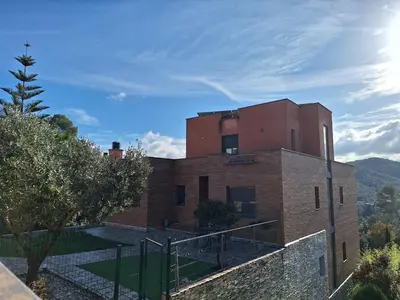 a large brick building with a sky background at Family-friendly house 20' from Barcelona in Castellví de Rosanés