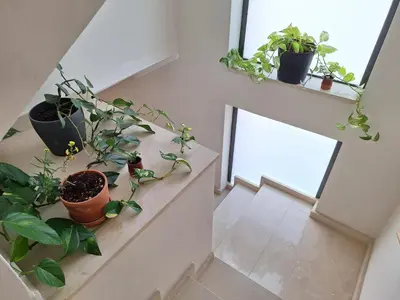 a kitchen with white cabinets and a green table at Family-friendly house 20' from Barcelona in Castellví de Rosanés