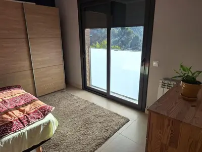 a living room with a couch and a red table at Family-friendly house 20' from Barcelona in Castellví de Rosanés