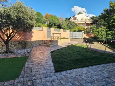 a fence with a building in the background next to a road at Family-friendly house 20' from Barcelona in Castellví de Rosanés