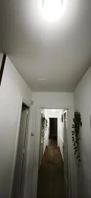 a hallway with a white ceiling and a hallway with plants at Playa de Sant Adrià de Besòs in Sant Adria de Besos