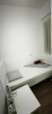 a bedroom with two beds and a window at Playa de Sant Adrià de Besòs in Sant Adria de Besos