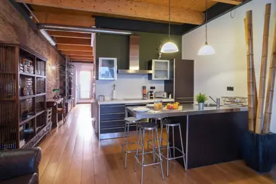 a kitchen with a large island with bar stools at Barcelona - Loft Paseo de gracia in Barcelona