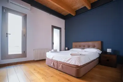 a bedroom with a large bed and a blue wall at Barcelona - Loft Paseo de gracia in Barcelona