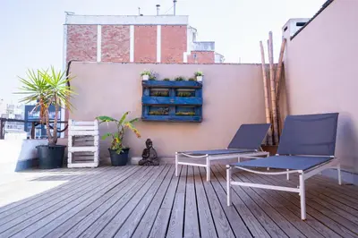 a deck with two chairs and a bench on a building at Barcelona - Loft Paseo de gracia in Barcelona