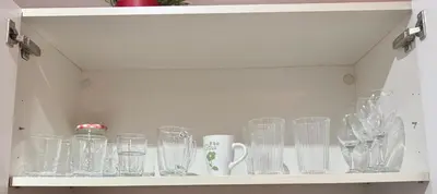 a cabinet filled with glass items on a shelf at Barceloneta Beach 2 in Barcelona
