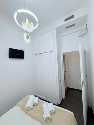 a bedroom with a bed and a chandelier at CENTRAL CITY Ivax in Barcelona