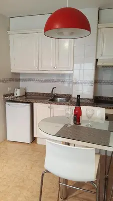 a kitchen with a counter with two wine glasses on it at Estrella Primero De Mayo in Sitges