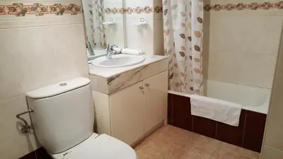 a bathroom with a toilet and a sink at Estrella Primero De Mayo in Sitges