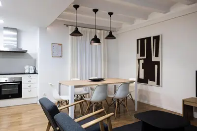a kitchen and dining room with a table and chairs at Stay U-nique Sant Pau in Barcelona