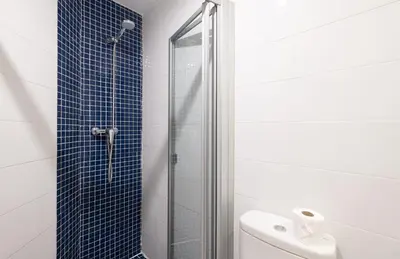 a bathroom with a glass shower and a toilet at Stay U-nique Sant Pau in Barcelona