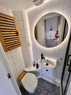 a bathroom with a sink and a mirror at Cozy Barceloneta Beach Flat - Newly Renovated in Barcelona