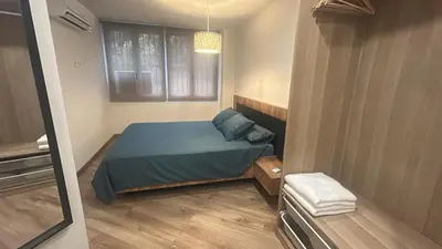 a small bedroom with a bed and a window at Villa Montjuic Apartments in Barcelona