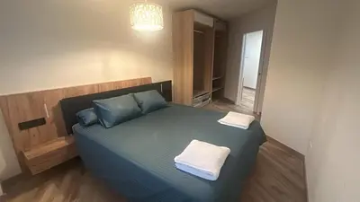 a bedroom with a bed with two towels on it at Villa Montjuic Apartments in Barcelona