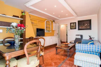 a living room with a table and a couch at Best sea views, 20 minutes to Barcelona in Montgat