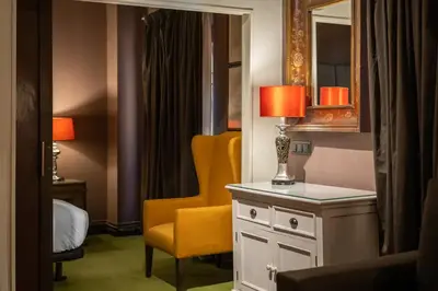 a hotel room with a yellow chair and a mirror at Stay U-nique Apartments Pou in Barcelona