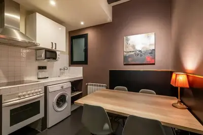 a kitchen with a table with chairs and a microwave at Stay U-nique Apartments Pou in Barcelona