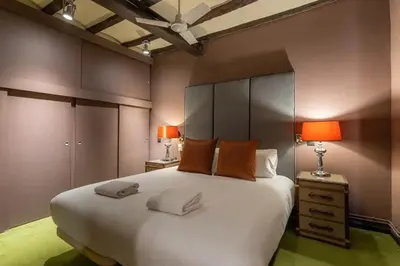 a bedroom with a large white bed with two lamps at Stay U-nique Apartments Pou in Barcelona