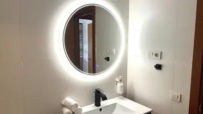 a bathroom with a sink and a mirror at Sunny apartment in the Olympic area by Prestigi in Terrassa
