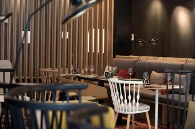 a restaurant with tables and chairs and a couch at Negresco Princess 4* Sup in Barcelona