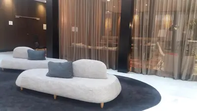 two white chairs with blue pillows in a room at Negresco Princess 4* Sup in Barcelona