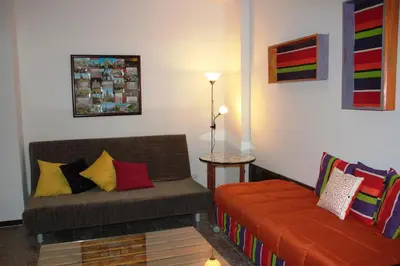 a living room with a couch with colorful pillows at Loft Sant Martí - Glories in Barcelona