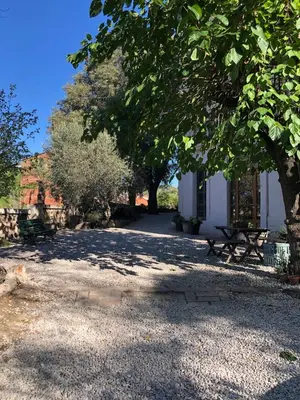 a park with benches and trees and a building at Torre d'en Malla in Martorell