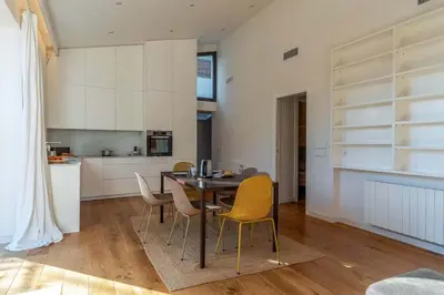 a kitchen and dining room with a table and chairs at Canela Homes COSTA LA PINEDA in Castelldefels