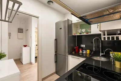 a white bathroom with a shower and a toilet at Stylish Apartment with Balcony in Central Barcelona in Barcelona