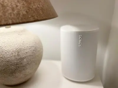 a white cup sitting on a table next to a lamp at Key White in Barcelona