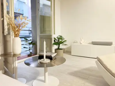 a living room with a table with a candle on it at Key White in Barcelona