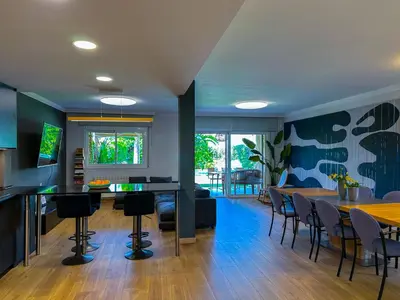 a living room with a couch and a flat screen tv at Villa Rocamar by Hello Homes Sitges in Sitges